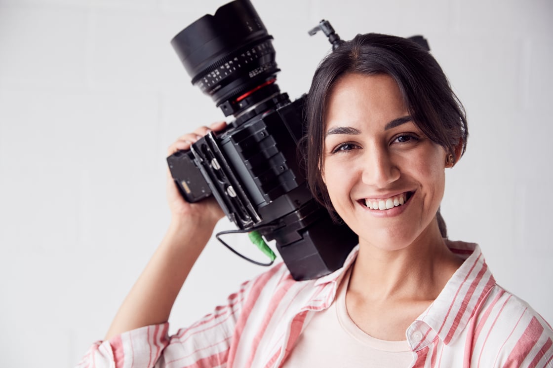 portrait-of-female-videographer-with-video-camera-2021-08-26-16-14-46-utc