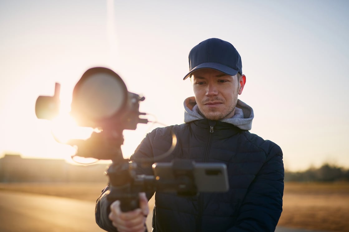 young-man-filming-with-camera-and-gimbal-portrait-2022-11-15-23-06-22-utc